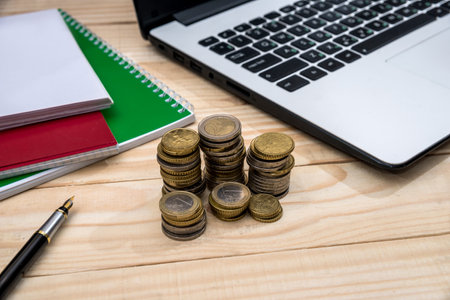 office desk with laptop, notepad, pen and calculatorの写真素材