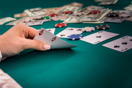 Combination of two aces in female hands on poker tableの写真素材