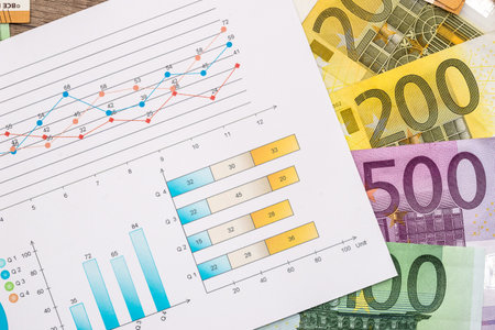 Financial graphics with euro banknotes close upの写真素材
