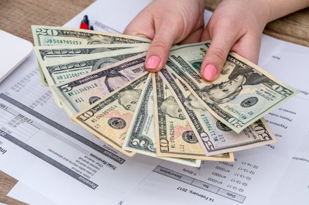 Dollar banknotes in woman hands, close up