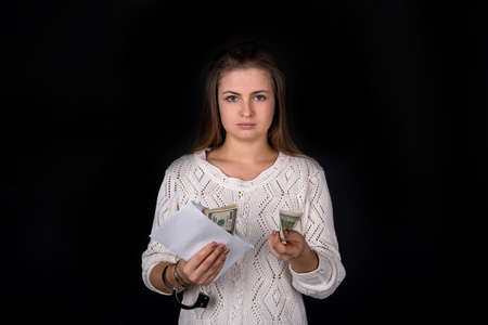 Freed woman taking out banknote from envelopeの写真素材