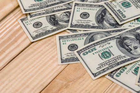 us dollar banknotes on wooden desk.
