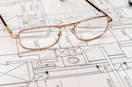 Engineer's drawing with spectacles, close up.の写真素材
