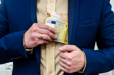 A businessman takes a bribe in euros.の写真素材