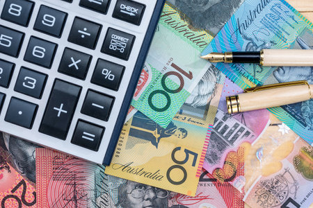Pen and calculator on australian dollar banknotesの写真素材