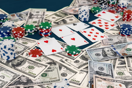 Casino table with dollars, chips and playing cardsの写真素材