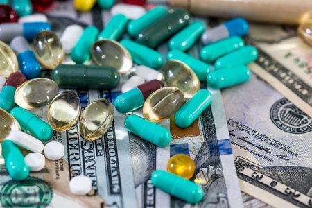 Colorful tablets on dollar banknotes background closeupの写真素材
