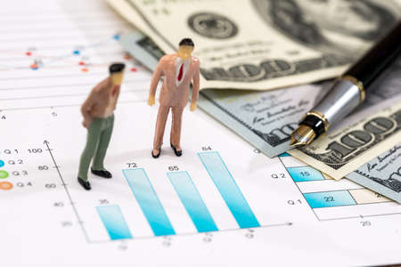 Small toys people discuss the schedule and dollars
