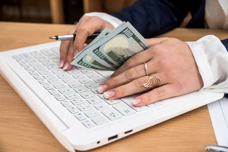 woman keeps the hands in dollarsの写真素材