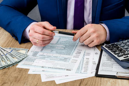 man fill tax form, account moneyの写真素材