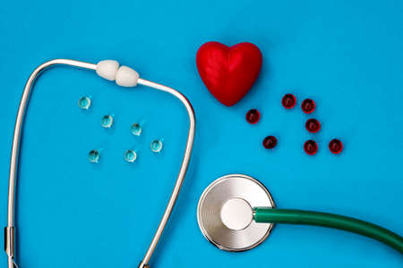 heart, stethoscope and pills are isolated on blue background