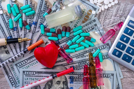 'Cost of health' conception with tablets, ampoules and syringesの写真素材