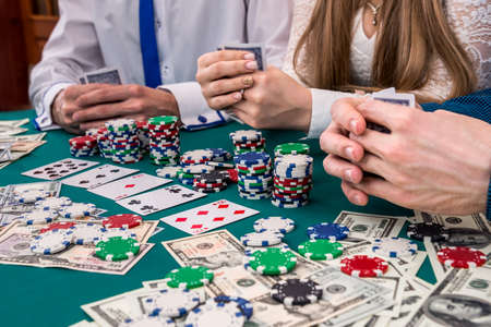 Friends company playing poker, gambling with money and chips