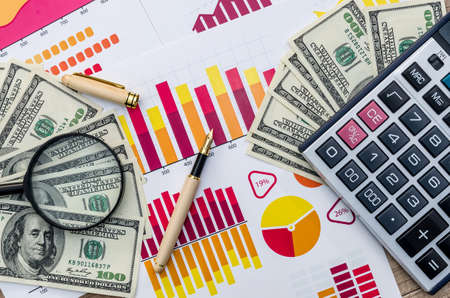 Business concept - graph, magnifier, dollar and calculatorの写真素材