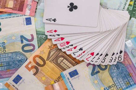 Playing cards on euro banknotes background, closeupの写真素材