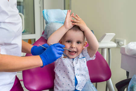 Little boy patient in dentistry sitting in chairの写真素材