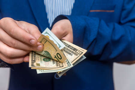 Male hands counting dollar banknotes close upの写真素材
