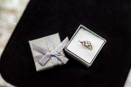 Golden ring with big stone in silver gift boxの写真素材