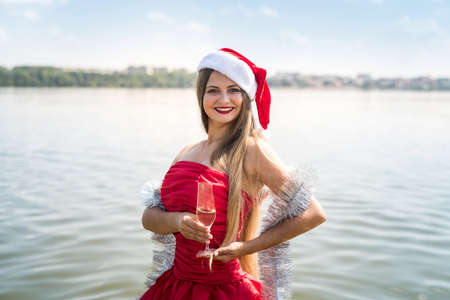 Girl with long hair holding glass of champagneの写真素材