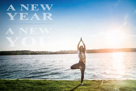 Athletic and slim woman doing yoga on lakeshoreの写真素材