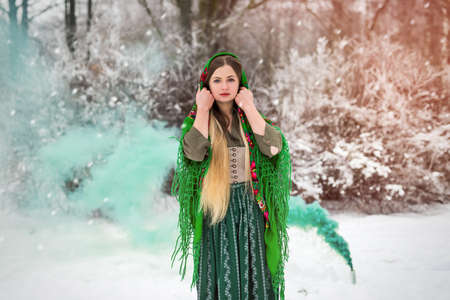 Woman in traditional clothes posing outdoor in parkの写真素材