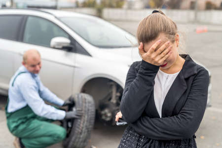 Angry woman on car service with broken car