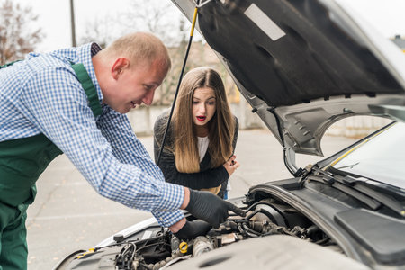 Worker explaining to woman problem in engineの写真素材