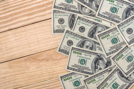 us dollar banknotes on wooden desk.の写真素材