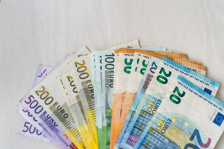 Colorful euro banknotes in fan on wooden tableの写真素材