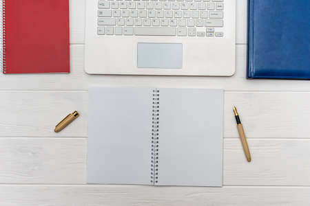 Laptop keyboard with empty list of paper and pen
