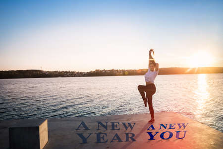 Slim woman posing on lake shore, new year conceptの写真素材