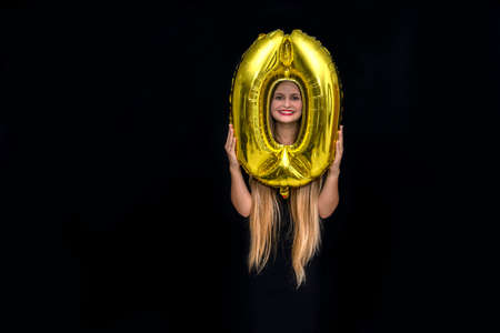Woman in santa hat holding 'zero' air balloon