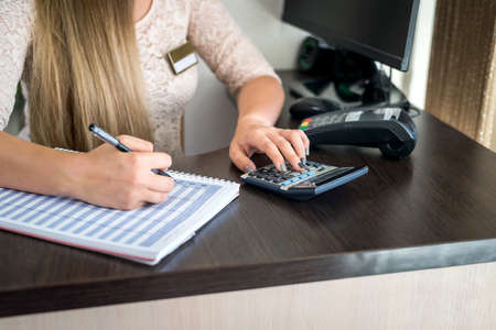 Administrator in beauty salon making notes to plannerの写真素材