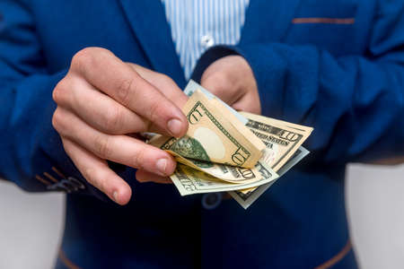 Male hands counting dollar banknotes close upの写真素材