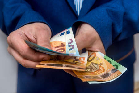 Businessman hands counting euro banknotes close upの写真素材