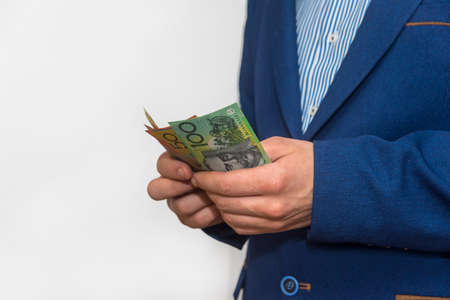 Male hands counting australian dollar banknotes, macroの写真素材