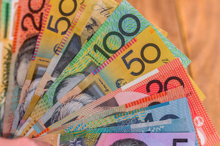 Australian dollars in fan on wooden deskの写真素材