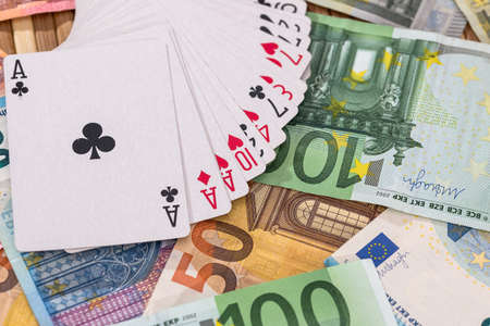Playing cards on euro banknotes background, closeupの写真素材