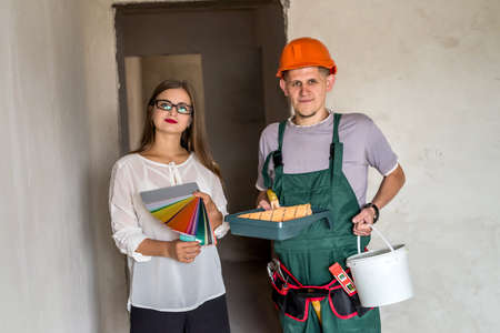 Customer and painter with color swatch and painting tools