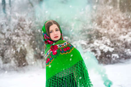 Beautiful ukrainian girl in shawl in winter park