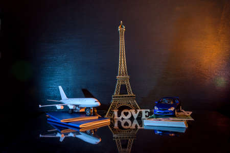 Travel concept with eiffel tower, toy car and plane