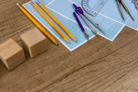 Wooden plank with drawing tools and millimeter paperの写真素材