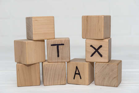Wooden cubes with text 'TAX' on it