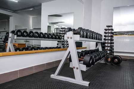 Dumbells in gym, sportive equipment close upの写真素材