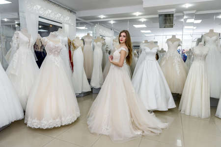 Attractive young bride is smiling in wedding salon