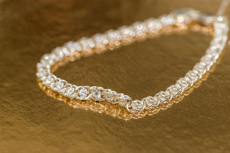 Elegant necklace with stones on golden background