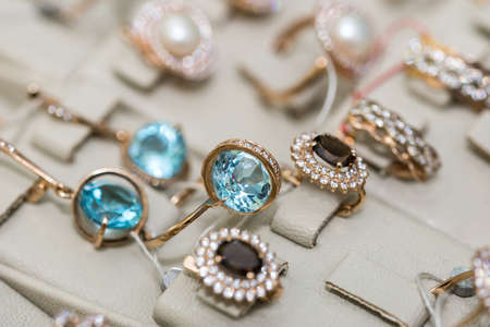 Jewelery with precious stones at showcase of a shopの写真素材