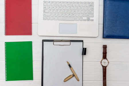 Laptop keyboard with empty list of paper and pen