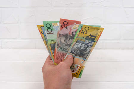 Australian dollar banknotes in hand giving for exchangeの写真素材