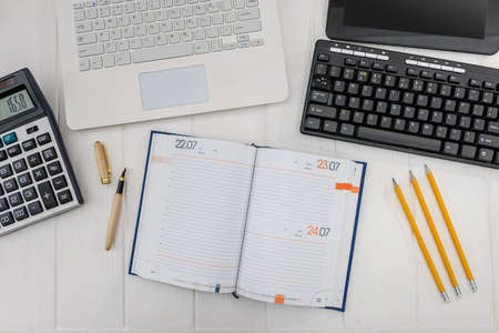 Top view at workplace, laptop, diary, pencil
